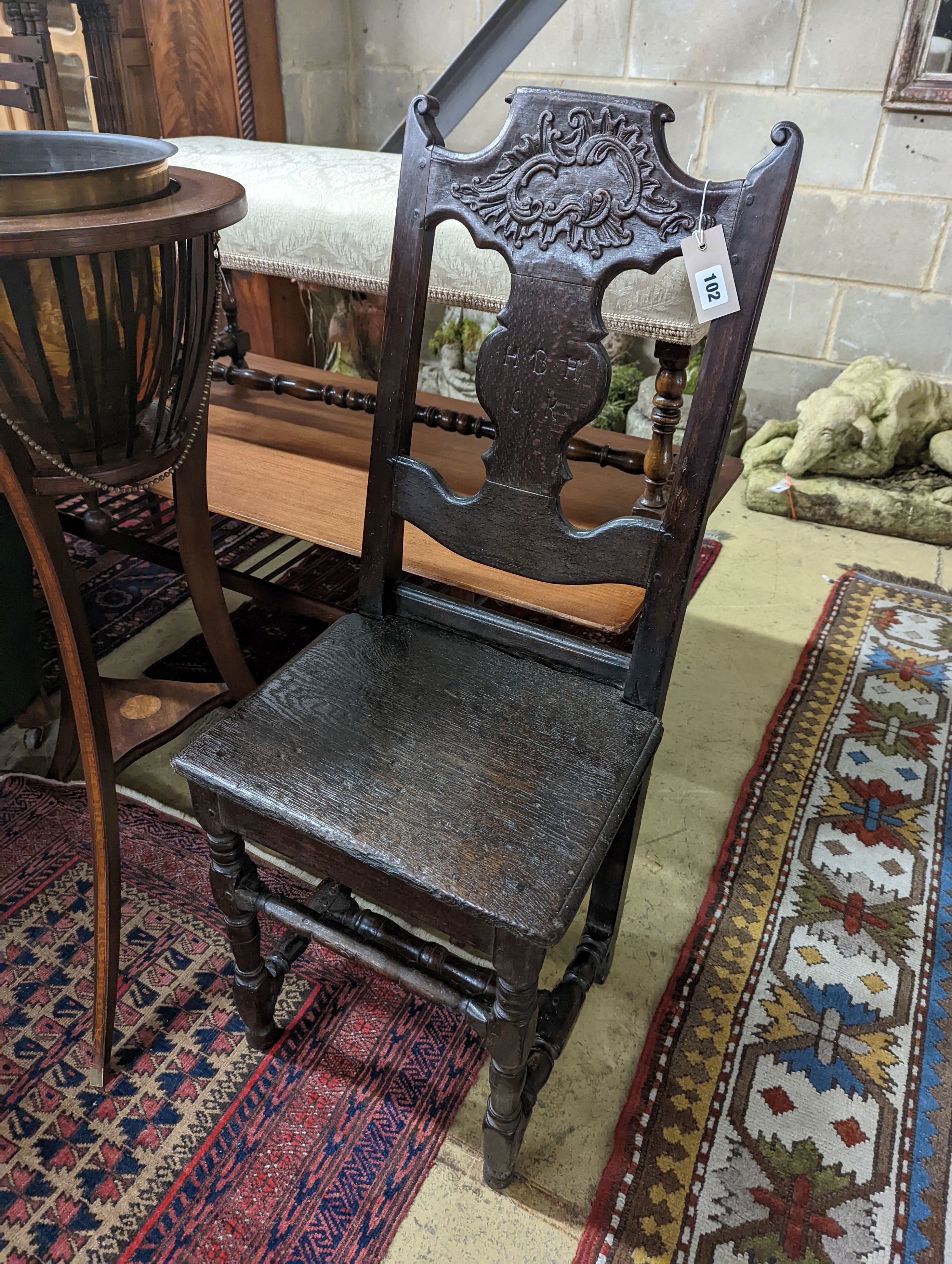 A 17th century style Continental oak back stool, width 40cm, depth 34cm, height 102cm